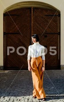 Girl makeup face fashion trend matching clothes. High waisted trousers keep Stock Photos