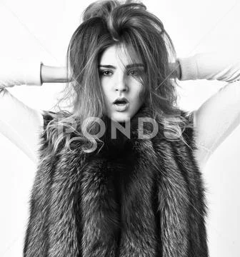 Girl makeup face long hairstyle wear fur vest white background. Fashion trend Stock Photos