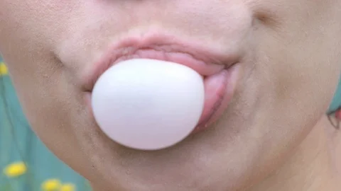 Girl making a big, huge bubble from chewing gum, close Stock Footage 92215105