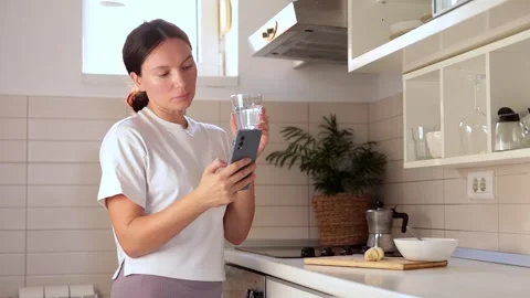 Girl making coffee in the kitchen early in the morning,drinks water, morning Stock Footage 258479637