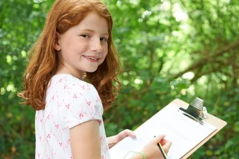 Girl Making Notes On School Nature Field Trip Stock Photos