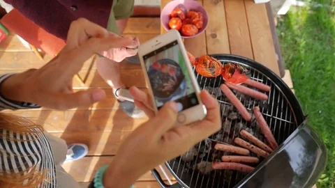 Girl making photo of grill sausages and tomatoes. Vegan bbq party. HD slowmotion Stock Footage