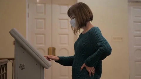 Girl in mask interacts with an interactive terminal in the museum Stock Footage 186049297