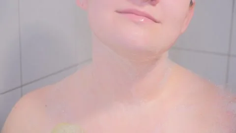 The girl massages the skin while soaping it with a washcloth. Close-up. Stock Footage 265658965