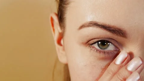 Girl massaging the skin under the eye Stock Footage