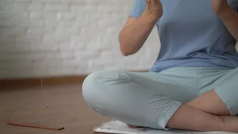 Girl meditates and changes the position of her hands in the lotus position next Stock Footage 170633768
