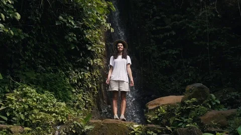 Girl meditates at the waterfall Stock Footage 129053789