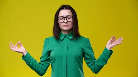 The girl is meditating, pulled her hands to the sides Stock Footage 164498203