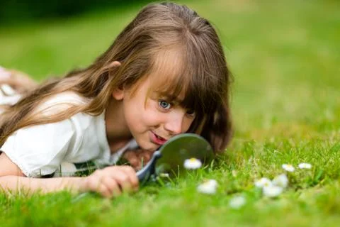 Girl with microscope Stock Photos