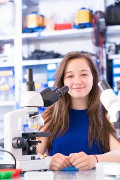 Girl with microscope Stock Photos