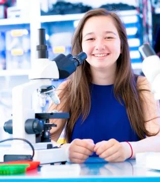 Girl with microscope Stock Photos