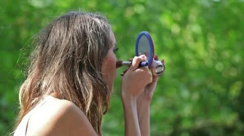 The girl with a mirror does a make-up Stock Footage 11700095