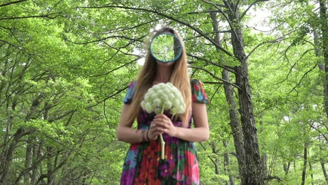Girl with a mirror instead of a face in the middle of pristine nature Stock Footage 130349422