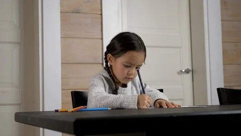 Girl (mixed race) at the table making drawing (Part 3) Stock Footage 122116563