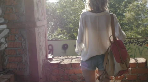 Girl model posing on camera walking through the ruins of an abandoned building. Stock Footage 60989863