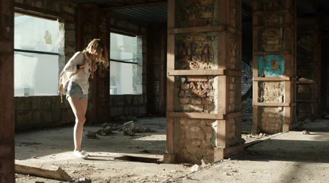 Girl model posing on camera walking through the ruins of an abandoned building. Stock Footage 60989906