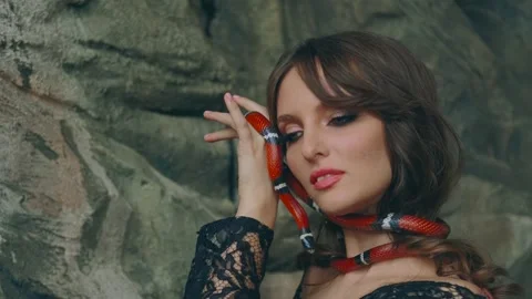 Girl Model posing with snake. Medieval woman look at camera. Shooting portait Stock Footage 314896273
