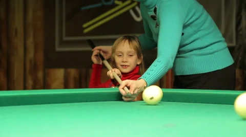 Girl with  mom plays billiards Stock Footage 44754763