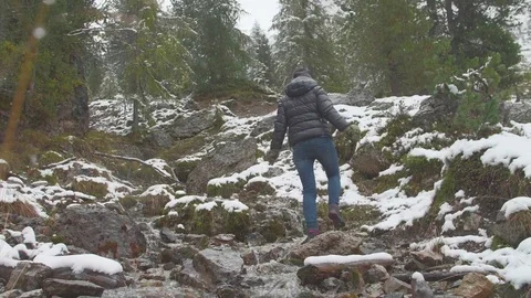 The girl in the mountains, dark gray sky, autumn, snow Stock Footage