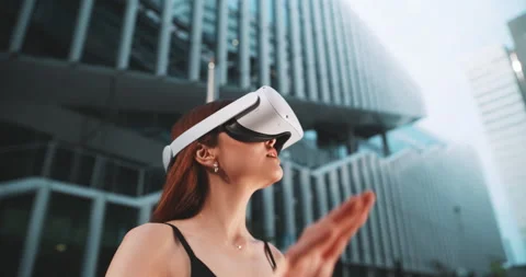 Girl moving her hand while using vr in the business district Stock Footage 201676472