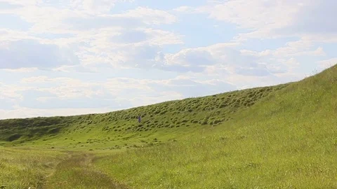 The girl is moving on the mountainside Stock Footage 76188924