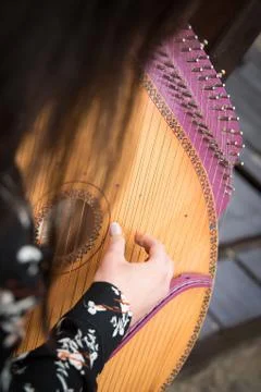 Girl musician plays a bandura, a Ukrainian musical instrument Stock Photos