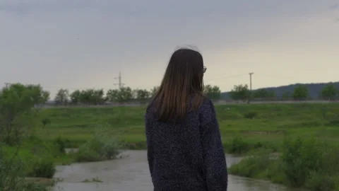 Girl in nature by river slowmotion Stock Footage