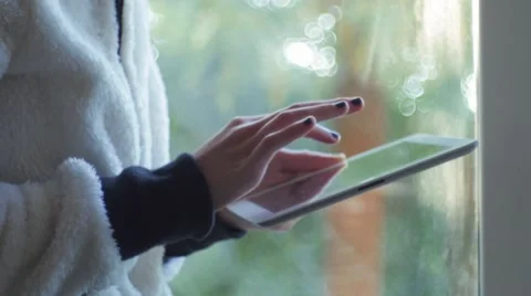 Girl near a window using a digital tablet Stock Footage 58833778