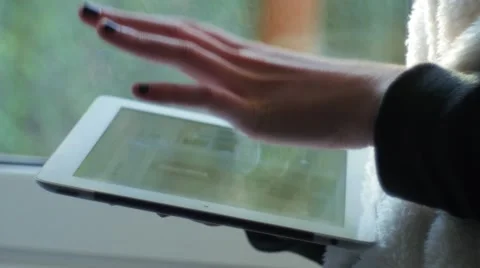 Girl near a window using a digital tablet Stock Footage 58838280