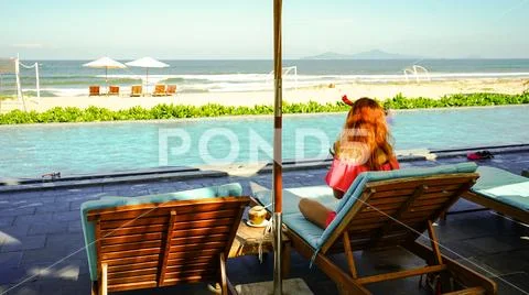 Girl with New year deer horns drinking coconut with 2019 drawing on the beach Stock Photos