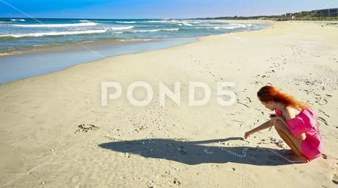 Girl with New year deer horns drinking coconut with 2019 drawing on the beach Stock Photos