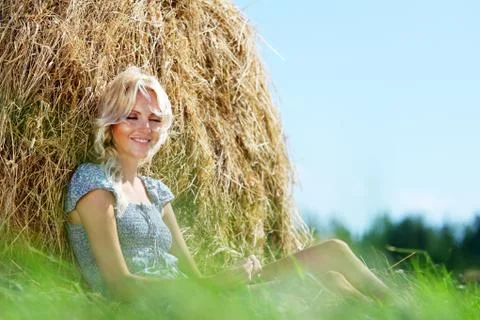 Girl next to a stack of hay Stock Photos