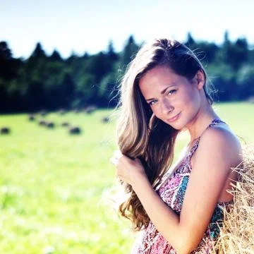 Girl next to a stack of hay Stock Photos