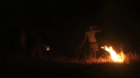 Girl by a night fire Stock Footage 80617372