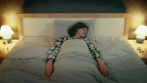 A girl at night lying in bed does not sleep well, see nightmares Stock Footage 206142781