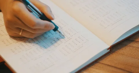 The girl notes the dates on the calendar Stock Footage