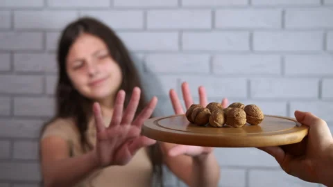 Girl with nut allergy refusing walnuts Stock Footage 326048137