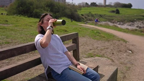 A girl by the ocean drinks tea. Stock Footage 194956671