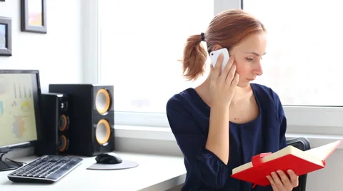 The girl in the office talking on smartphone Stock Footage 61939934