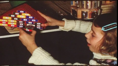 Girl opening Christmas calendar (vintage 8 mm amateur film) Stock Footage