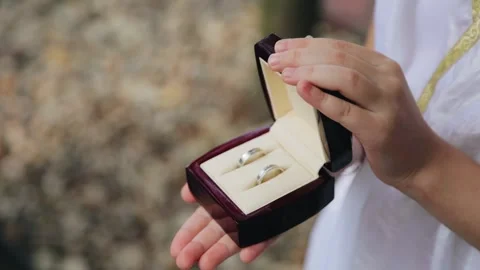 The girl opens the box containing the wedding wedding rings. Close-up shooting Stock Footage 307224390