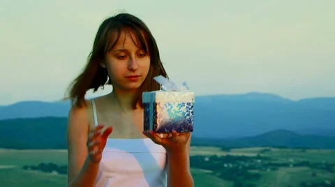 Girl opens a box of fun Video stock 52721806