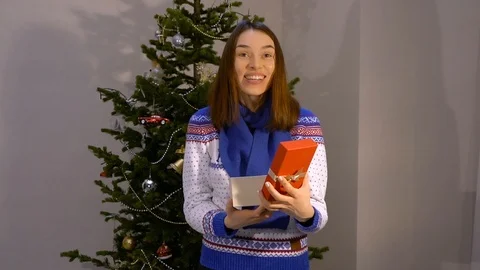 Girl opens a box with a gift Stock Footage 121534784
