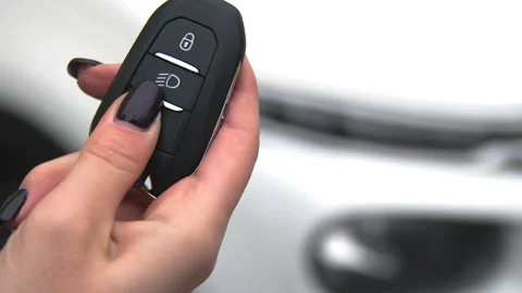 The girl opens the car with an automatic key. 4K, Slow motion, close-up Video stock 144489242
