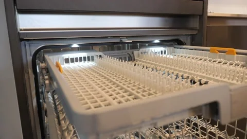 The girl opens the dishwasher. Stock Footage 151445932