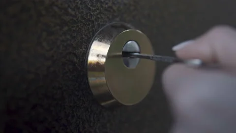 Girl opens door lock key close-up Stockbeeldmateriaal 110875666