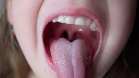 girl opens her mouth wide and pulls out ... | Stock Video  