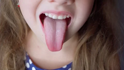 girl opens her mouth wide and pulls out ... | Stock Video