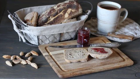 Girl opens her small hand with a young jar with strawberry jam. With the help of Stock-Footage 79831991
