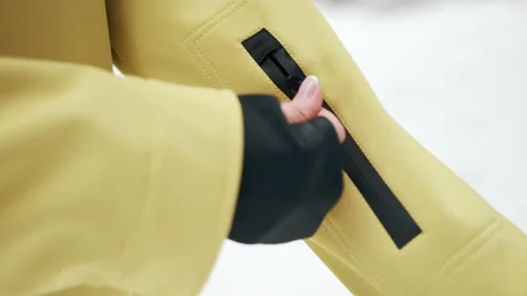 The girl opens the locks on the yellow jacket. Close up Video stock 144693682